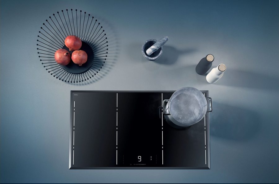 A black glass-ceramic cooktop seen from above